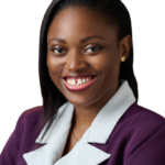 Potrait of Jane OLUWADARE turned slightly to the side, and with a bright smile. She is wearing a purple blazer with white lapels and small gold butterfly earring studs. Her hair is down in a side part