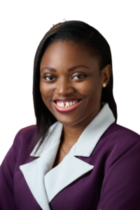 Potrait of Jane OLUWADARE turned slightly to the side, and with a bright smile. She is wearing a purple blazer with white lapels and small gold butterfly earring studs. Her hair is down in a side part