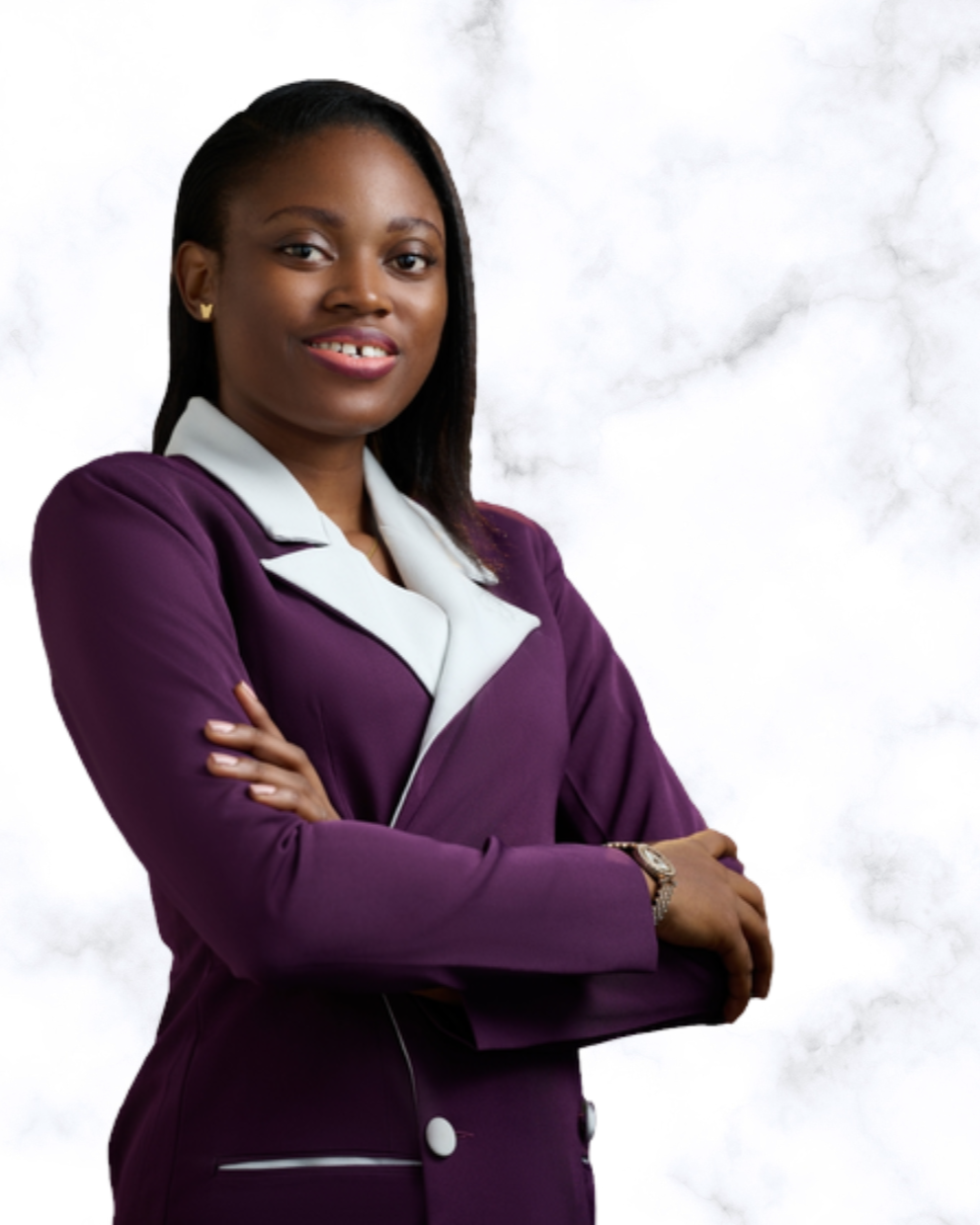 Picture of Jane OLUWADARE turned slightly to the side, with a bright smile and her arms crossed. She is wearing a purple blazer dress with white lapels and small gold butterfly earring studs. Her hair is down in a side part